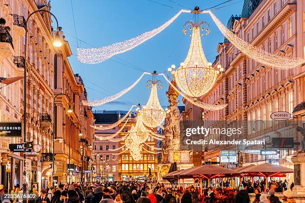 beautiful chandelier christmas lights decorations on graben shopping street in winter, vienna, austria - austria stock pictures, royalty-free photos & images