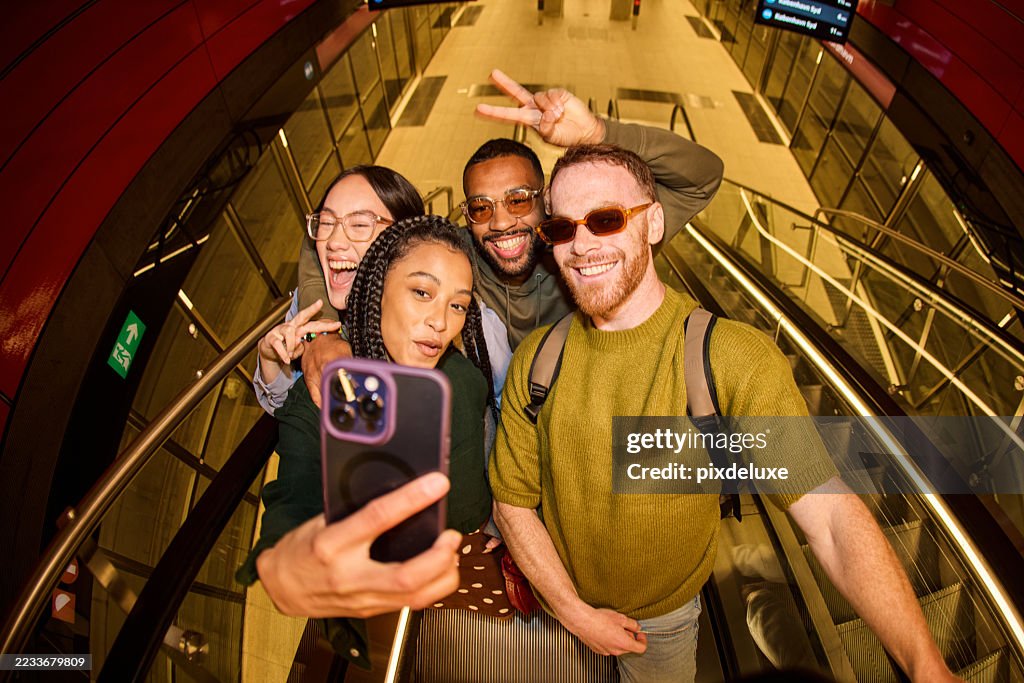 Group of diverse friends taking a selfie on an escalator