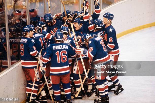 Players from the United States Ice Hockey team celebrate after defeating Team Finland to win the gold medal during the Men's Ice Hockey Final game on...