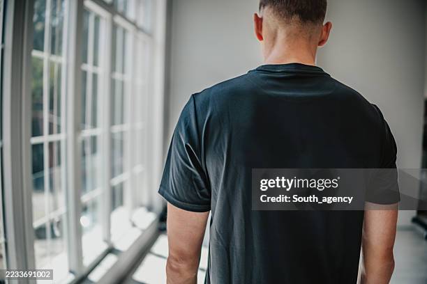 men's t-shirt mockup showcasing casual fashion with a cool attitude for contemporary designs - shirt mockup stock pictures, royalty-free photos & images