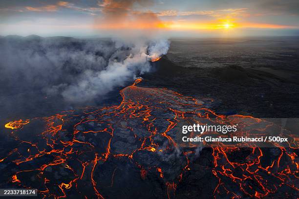 aerial view of volcanic eruption at sunset,iceland - volcanic rock stock pictures, royalty-free photos & images