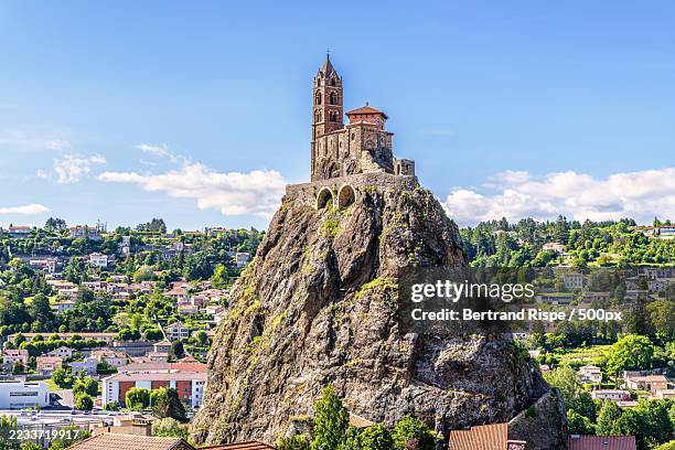 historic chapel on rocky hill overlooking cityscape,aiguilhe,france - auvergne stock pictures, royalty-free photos & images