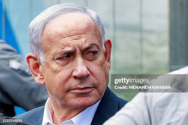 Israel's Prime Minister Benjamin Netanyahu visits the scene of a shooting at the Ramot road junction in Israeli-annexed east Jerusalem on September...