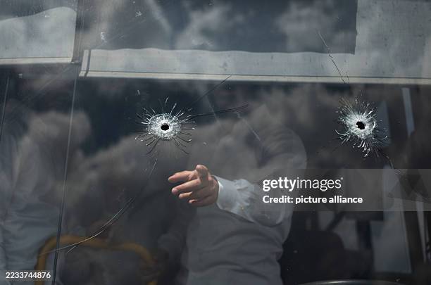 September 2025, Israel, Jerusalem: Gunshots are seen on a wind-shield of a bus at the bus stop where a shooting attack took place in Jerusalem. The...