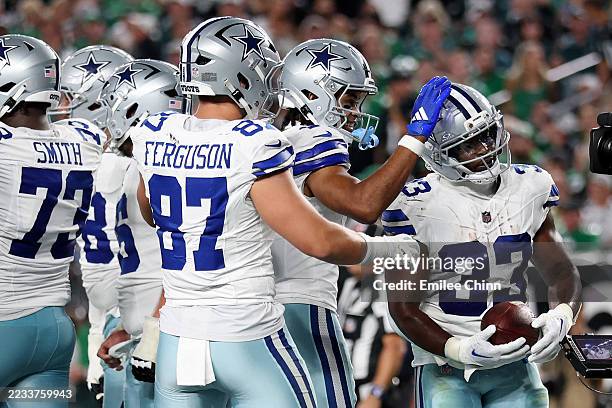 Javonte Williams of the Dallas Cowboys celebrates with teammates after scoring his second one yard touchdown against the Philadelphia Eagles during...