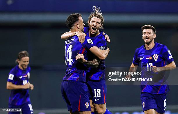 Croatia's midfielder Kristijan Jakic celebrates with Croatia's forward 14 Ivan Perisic after scoring a goal during the FIFA World Cup 2026 Group C...