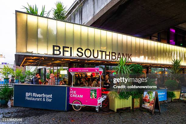 people sitting outside bfi (british film institute) southbank in london, uk - south bank london stock pictures, royalty-free photos & images