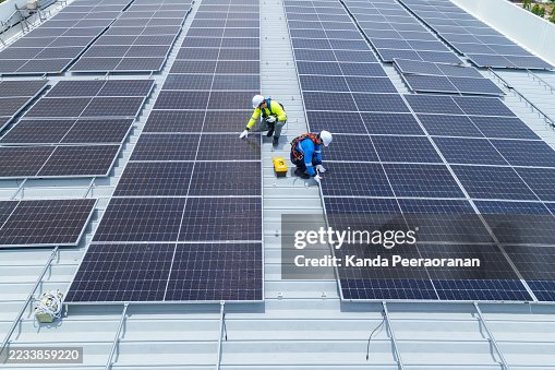 Technicians maintaining rooftop solar panel system Technicians maintaining rooftop solar panel system