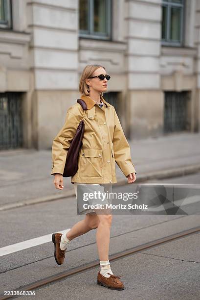 Marlies Pia Pfeifhofer is seen wearing an oak beige utility Spring Decker jacket with pointed contrasting corduroy collar, front button fastening and...