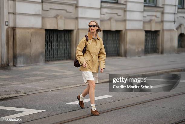 Marlies Pia Pfeifhofer is seen wearing an oak beige utility Spring Decker jacket with pointed contrasting corduroy collar, front button fastening and...