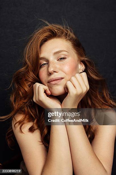 portrait of a red-haired woman posing gracefully with a natural expression - dyed hair stock pictures, royalty-free photos & images