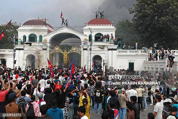 Protesters gather at the Singha Durbar, the main administrative building for the Nepal government, in Kathmandu on September 9 a day after a police...