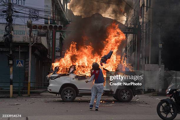 Protester draped in Nepal's national flag sets fire to a government vehicle at Mahendrapool in Pokhara, Nepal, on September 9 during a Gen Z-led...