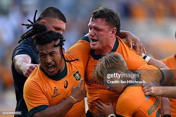 Angus Bell of the Wallabies celebrates scoring a try with Brandon Paenga-Amosa and Tate McDermott of the Wallabies during The Rugby Championship...