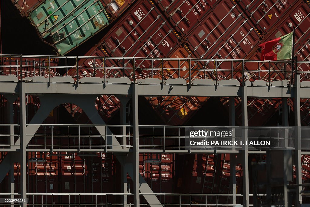 Container Straddle Crash Stacks of leaning shipping containers are seen behind a Portuguese ...