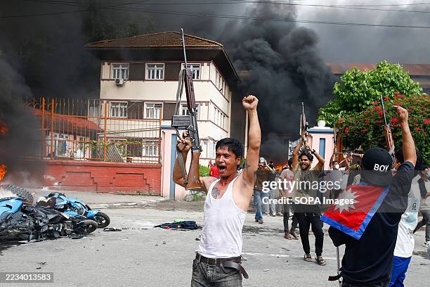 Protester holds a gun before capturing Singha Durbar, which housed the office of the former Prime Minister and other ministries, amid raging Gen Z...