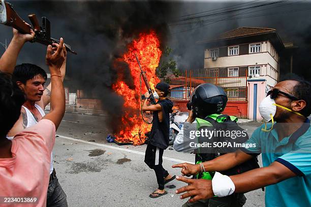 Protester holds a gun before capturing Singha Durbar, which housed the office of the former Prime Minister and other ministries, amid raging Gen Z...