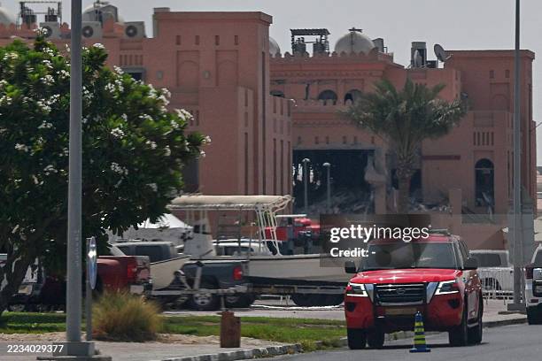 Picture taken from a distance shows in the background the damaged building housing members of Palestinian militant group Hamas's political bureau...