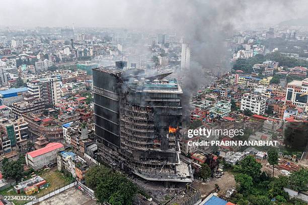 Smoke billows from the burning Hilton Hotels, a day after it was set ablaze by protesters in Kathmandu on September 10, 2025. Nepali demonstrators...