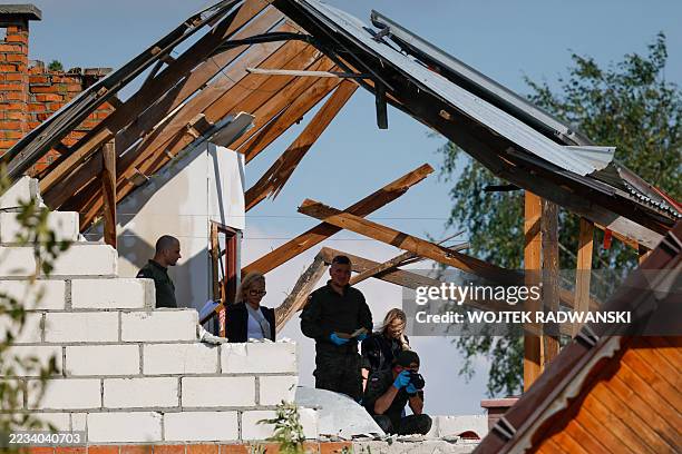 Police and army inspect damage to a house destroyed by debris from a shot down Russian drone in the village of Wyryki-Wola, eastern Poland, on...