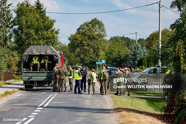 Police and army gather to inspect a house destroyed by debris from a shot down Russian drone in the village of Wyryki-Wola, eastern Poland, on...