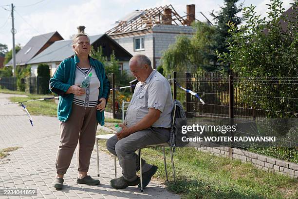 Alicja Wesolowska and her husband Tomasz Wesolowski are seen in front of their damaged house destroyed by debris from a shot down Russian drone in...
