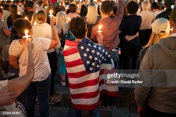An attendee wears a U.S. Flag during a candlelight vigil for Turning Point USA Founder Charlie Kirk on September 10, 2025 in Seattle, Washington....