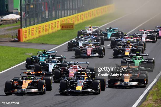 Lando Norris of Great Britain driving the McLaren MCL39 Mercedes leads Max Verstappen of the Netherlands driving the Oracle Red Bull Racing RB21...