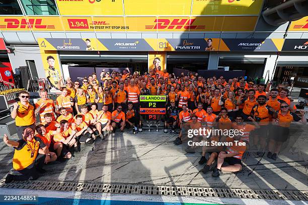Second placed Lando Norris of Great Britain and McLaren Third placed Oscar Piastri of Australia and McLaren and the McLaren team celebrate during the...
