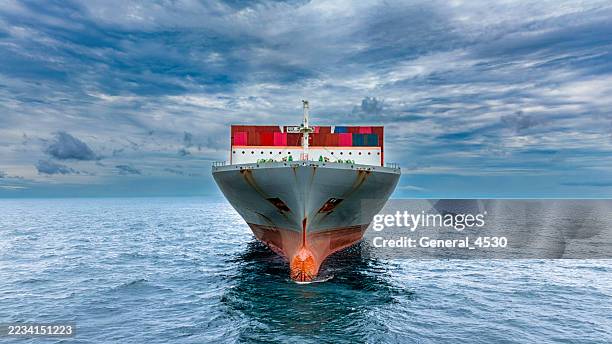 aerial view of cargo ship runing on sea close warehouse harbor. - front view stock pictures, royalty-free photos & images