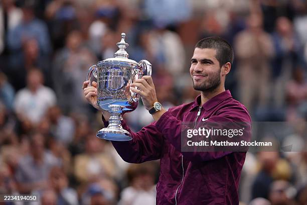 Carlos Alcaraz of Spain poses with his trophy after defeating Jannik Sinner of Italy during their Men's Singles Final match on Day Fifteen of the...