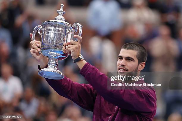 Carlos Alcaraz of Spain poses with his trophy after defeating Jannik Sinner of Italy during their Men's Singles Final match on Day Fifteen of the...