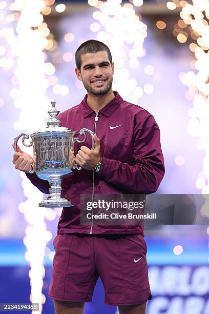 Carlos Alcaraz of Spain poses with his trophy after defeating Jannik Sinner of Italy during their Men's Singles Final match on Day Fifteen of the...