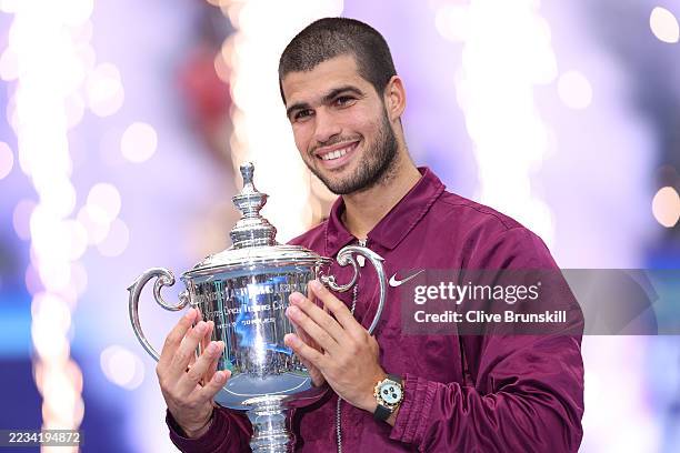 Carlos Alcaraz of Spain poses with his trophy after defeating Jannik Sinner of Italy during their Men's Singles Final match on Day Fifteen of the...