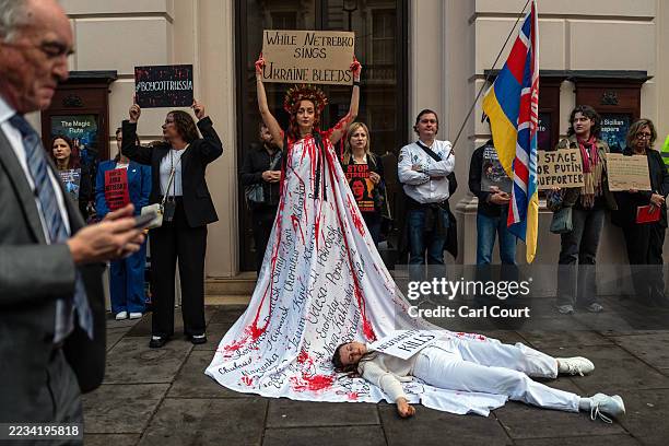 Ukrainian women take part in a performance protest outside the Royal Opera House as they demonstrate against the performance of Russian soprano Anna...