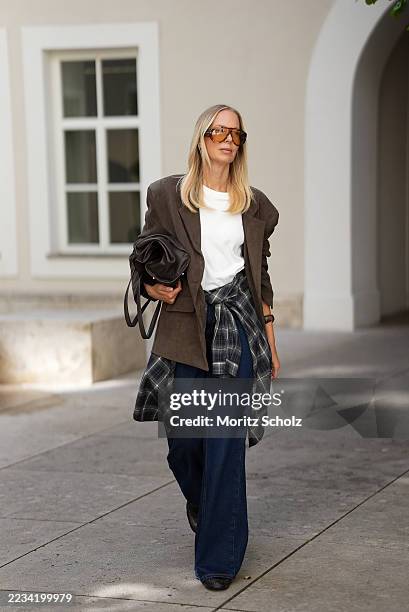 Mirja Klein is seen wearing an oversized chocolate-brown Peoria faux suede blazer with notch lapels, flap pockets and padded shoulders from The...