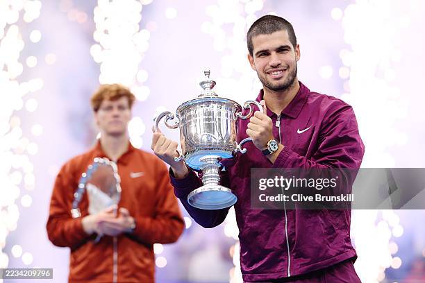 Carlos Alcaraz of Spain poses with his trophy after defeating Jannik Sinner of Italy during their Men's Singles Final match on Day Fifteen of the...