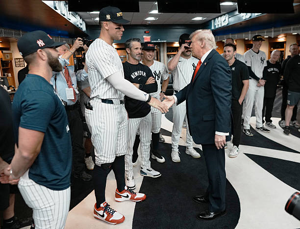 President Donald Trump shakes hands with Aaron Judge of the New York Yankees in the locker room before a game against the Detroit Tigers at Yankee...