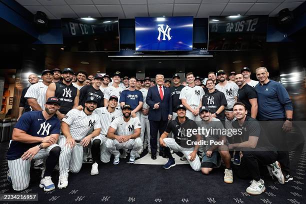 President Donald Trump poses for a photo with members of the New York Yankees in the locker room before a baseball game against the Detroit Tigers at...