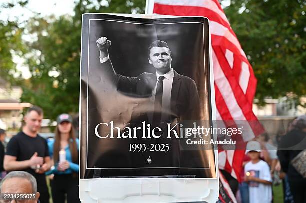 Residents of Lemont, Illinois, come together in a serene park setting to pay tribute to Charlie Kirk during a vigil on September 11, 2025.Turning...
