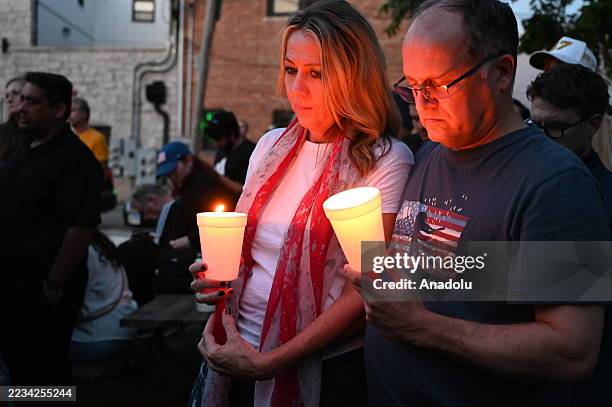 Residents of Lemont, Illinois, come together in a serene park setting to pay tribute to Charlie Kirk during a vigil on September 11, 2025.Turning...
