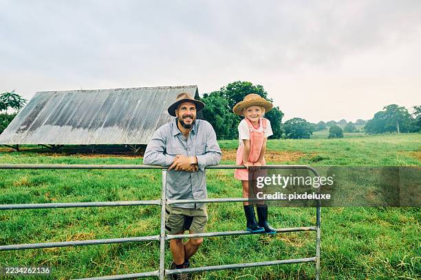 happy farmer and daughter smiling at each other in a sustainable farm in australia - local produce stock pictures, royalty-free photos & images
