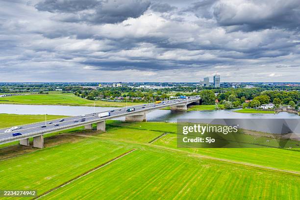 bridge over the river ijssel near zwolle - ponte em arco imagens e fotografias de stock