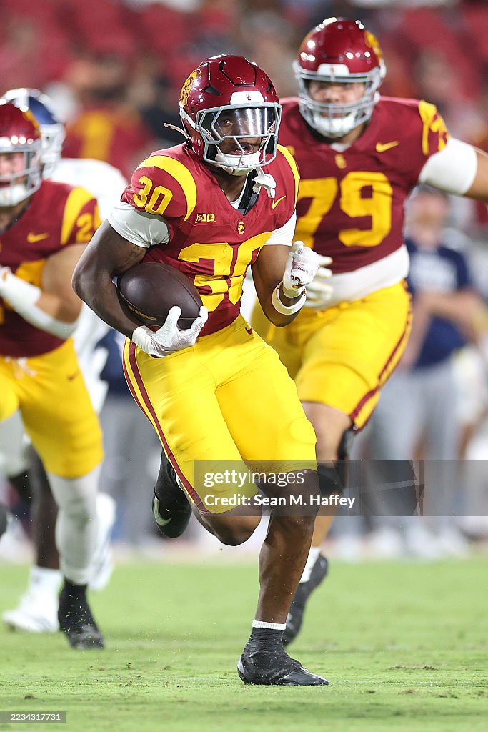 King Miller of the USC Trojans rushes with the ball during the
