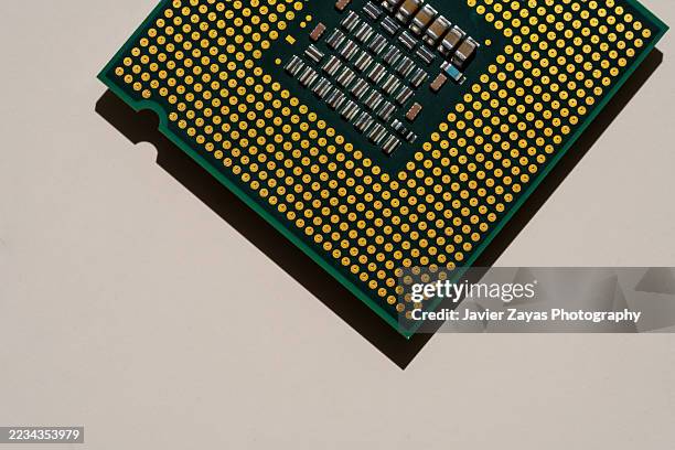 cpu processor unit showing its golden pins and electronic components - computer cpu stock pictures, royalty-free photos & images