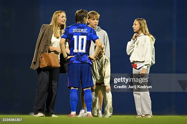 Luka Modric of Croatia reacts with members of his family on the pitch after the team's victory in the FIFA World Cup 2026 qualifier match between...