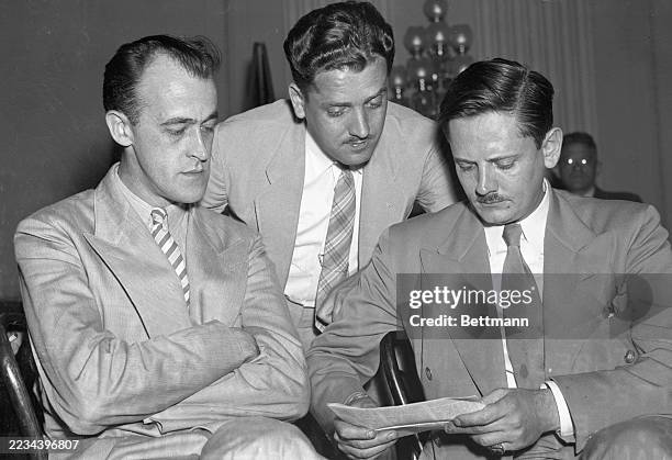 Frank Davin, Chicago publicist, James Metcalfe, and John Metcalfe prepare to testify before the House of Representatives Committee on Un-American...