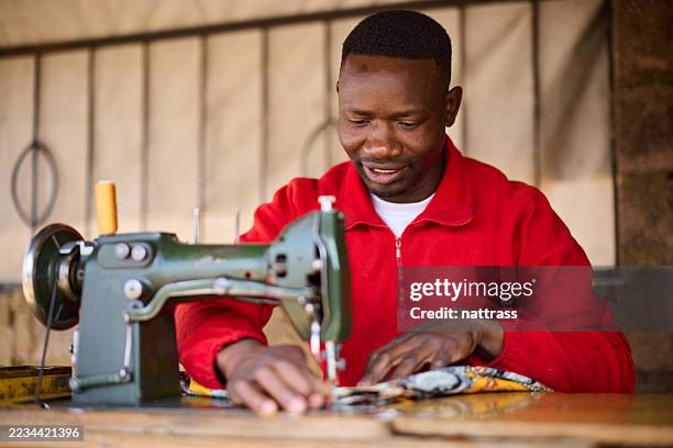 tailor sewing dress on sewing machine - south african culture stock pictures, royalty-free photos & images
