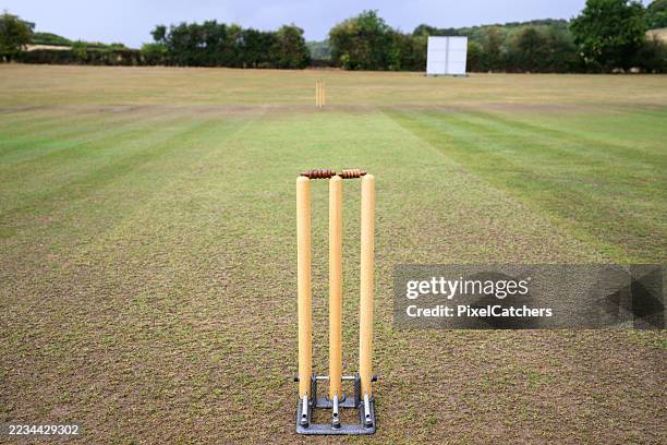 cricket wickets on an open field ready for a game - cricket field stock pictures, royalty-free photos & images