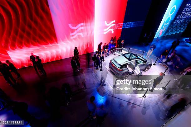 Visitors attend the booth of German car producer Volkswagen Group on the opening day of the IAA MOBILITY 2025 automobile fair on September 09, 2025...